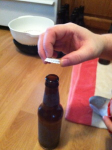 Placing the serialized bottle cap on the bottle.